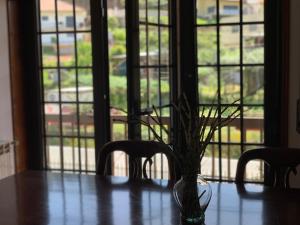 a vase sitting on a table in front of a window at Casa Pedravedra in Mondim de Basto