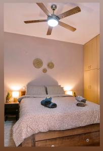 a bedroom with a bed with a ceiling fan at Morpheus Realm Apartment in Ioannina