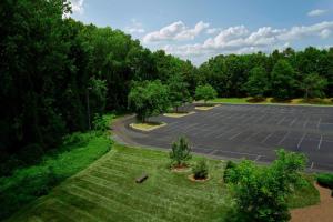 an aerial view of a parking lot with trees at Sheraton Charlotte Airport in Charlotte