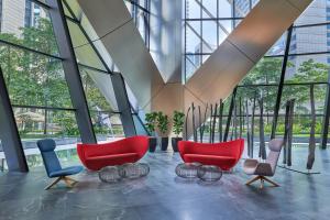 a large lobby with red chairs and windows at Element Kuala Lumpur in Kuala Lumpur