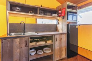 a kitchen with a sink and a refrigerator at BIG4 Apollo Bay Pisces Holiday Park in Apollo Bay