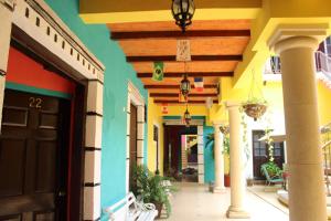 a hallway of a building with colorful walls at Hotel Guaranducha Inn in Campeche