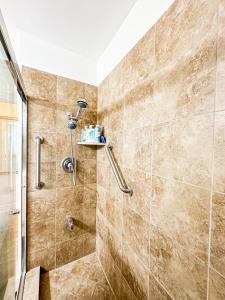 a shower stall in a bathroom with tiles at Charming 3BR House - Hal-UC in Los Angeles