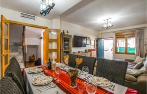 a dining room with a table with wine glasses on it at 4 Bedroom Nice Home In Villarrubia in Villarrubia