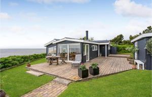 a house with a deck with a view of the ocean at Cozy Home In Esbjerg V With Wifi in Esbjerg