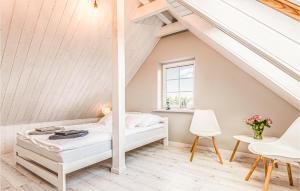 a bedroom with a bed in a attic at Awesome Home In Grzybowo With 5 Bedrooms And Wifi in Grzybowo
