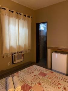 a bedroom with a bed with towels on it at Pousada do Suiço in Fortaleza