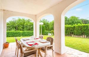 - une table et des chaises blanches sur la terrasse dans l'établissement Gorgeous Home In Maanet De La Selva With Kitchen, à Maçanet de la Selva