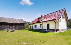 a house with a red roof and a grass yard at Pet Friendly Home In Szczytno With Wifi in Szczytno