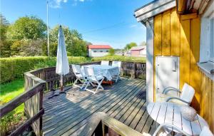 une terrasse avec une table, des chaises et un parasol dans l'établissement Amazing Home In Vstra Karup With Wifi, à Västra Karup