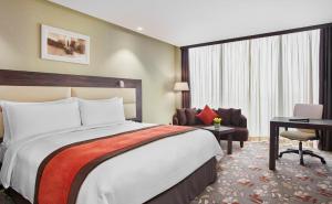 a hotel room with a bed and a desk at Crowne Plaza Kuwait Al Thuraya City, an IHG Hotel in Kuwait