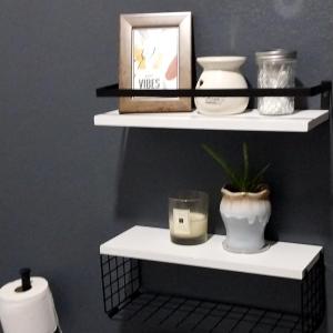 a shelf with candles and a plant on it at Samm's Apartment in Hyde Park