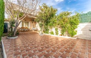 a brick patio with trees and a house at Awesome Home In Miami Playa With Wifi in Miami Platja +29 photos