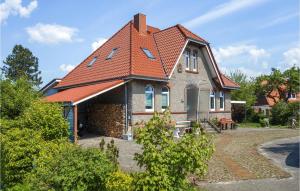 a house with an orange roof at Cozy Apartment In Wurster Nordseekste With Wifi in Hofe