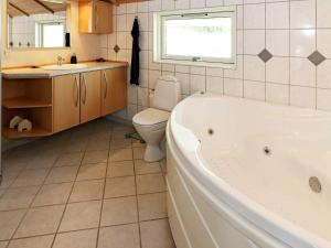 a bathroom with a tub and a toilet and a sink at 8 person holiday home in Hadsund-By Traum in Hadsund +42 photos