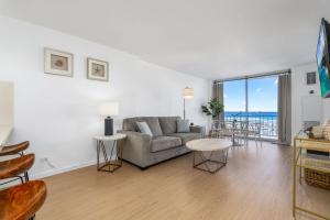 a living room with a couch and a table at *Remodeled Oceanfront in Waikiki - Ilikai Marina in Honolulu