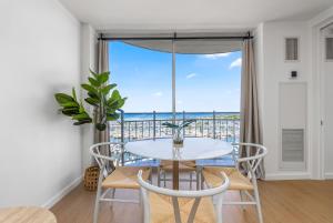 a dining room with a table and chairs and a large window at *Remodeled Oceanfront in Waikiki - Ilikai Marina in Honolulu