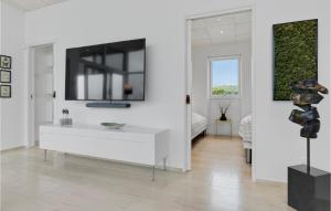 a white room with a sink and a television on a wall at Nice Home In Haderslev With 2 Bedrooms, Wifi And Outdoor Swimming Pool in Haderslev