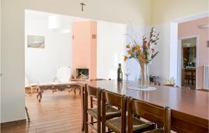 a dining room with a table with a vase of flowers at Casa Marina in Santa Margherita
