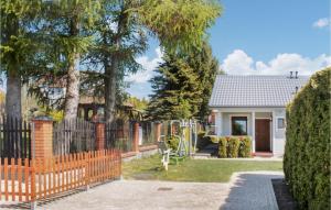 a wooden fence in front of a house at Stunning Home In Sianozety With Wifi And 2 Bedrooms in Sianozety