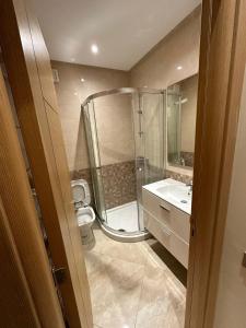 a bathroom with a shower and a toilet and a sink at CASA BAY BEACH OMK 2 in Sidi Rahal