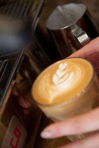a person is holding a cup of coffee at CASA Kamakura Espresso&BED in Kamakura