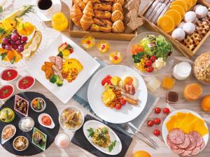 a table filled with plates of food and fruits at Tokyo Bay Tokyu Hotel in Urayasu