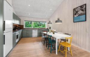 a kitchen with a white table and chairs at Gorgeous Home In Oksbl With Sauna in Oksbøl