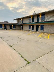 an empty parking lot in front of a building at Travel Inn & Suites in Emporia