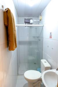 a bathroom with a shower and a toilet and a sink at Noronha Economy Suítes - Hospedagem com melhor localização e custo benefício da ilha in Fernando de Noronha