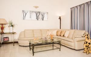 a living room with a couch and a table at Whitehouse Residencies in Colombo