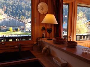 a kitchen with a window with a view of a barn at Appartement Crest-Voland, 2 pièces, 6 personnes - FR-1-733-52 in Crest-Voland