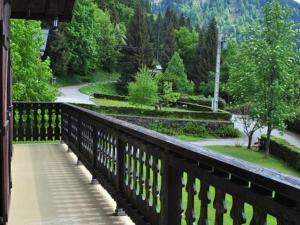 a wooden balcony with a view of a park at Chalet Cohennoz, 4 pièces, 10 personnes - FR-1-733-29 in Cohennoz