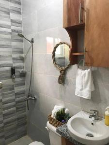 a bathroom with a shower and a toilet and a sink at Beautiful sea front apartment in Paraíso