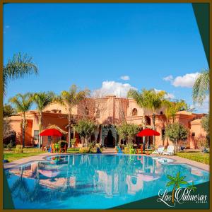 a resort with a swimming pool in front of a building at Las Palmeras Guest House in Marrakesh
