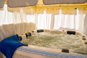 a tub in a boat with water in it at Las Palmeras Guest House in Marrakesh +120 photos