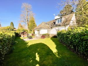 a large white house with a large yard with a lawn at Granton Lodge in Far Sawrey
