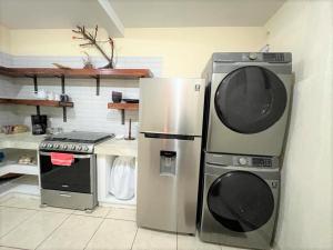 Il comprend une cuisine équipée d'un réfrigérateur et d'une cuisinière. dans l'établissement COMFY. Full internet, kitchen, washer and dryer, Netflix, à Chimaltenango