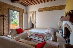 a living room with a bed and a fireplace at Casetta rustica nel Chianti in San Donnino