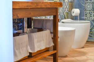 a bathroom with a sink and a toilet at Casetta rustica nel Chianti in San Donnino +18 photos
