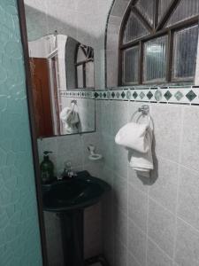 a bathroom with a sink and a mirror at Habitación Agradable in Bogotá