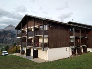 a building with balconies on the side of a hill at Studio cosy avec terrasse, équipements complets, parking et casier à skis - Crest-Voland - FR-1-733-118 in Crest-Voland