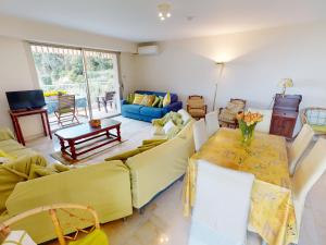 a living room with yellow couches and a table at Grand 3P à Menton avec terrasses et parkings - FR-1-196-331 in Menton
