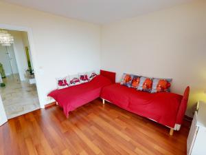 a living room with two red couch and wooden floors at Grand 3P à Menton avec terrasses et parkings - FR-1-196-331 in Menton +10 photos