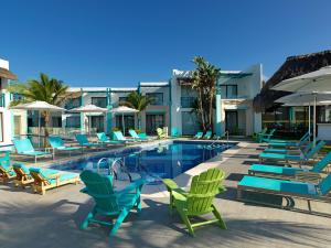 a pool with lounge chairs and a bunch ofitures at Margaritaville Island Reserve Riviera Cancún - An All-Inclusive Experience for All in Puerto Morelos