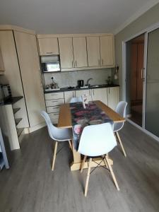 a kitchen with a table and chairs in a room at Mulberry Gardens Self Catering in Swakopmund