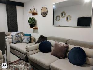 a living room with two couches and a flat screen tv at Apartamento sector exclusivo acogedor in Bogotá