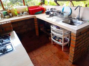 a kitchen with a sink and a counter top at Saranna Cabaña in San Agustín