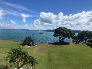 a sail boat on a large body of water at Luxury Waterfront in One Tree Point