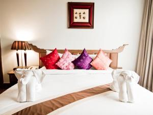 Säng eller sängar i ett rum på Laithong Hotel